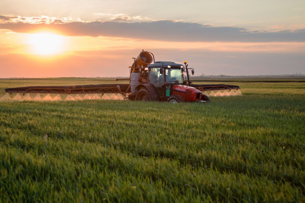 Tractor in a field at sunset